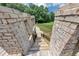 Stone walkway featuring a wooden staircase with wrought iron railings, surrounded by brick walls at 4233 Sandstone Shores Dr, Stonecrest, GA 30038