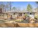 Home exterior showcasing a wooden deck, a well-maintained lawn, and a classic fence at 46 Cooper Lake Sw Rd, Mableton, GA 30126