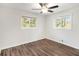 Bright bedroom features vinyl floors, a modern ceiling fan, and sun-filled windows at 46 Cooper Lake Sw Rd, Mableton, GA 30126