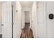 Hallway with hardwood floors, white doors and neutral paint at 46 Cooper Lake Sw Rd, Mableton, GA 30126