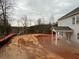 The covered patio and backyard are ready for landscaping and outdoor enjoyment at 6945 Melody Ridge Rd, Buford, GA 30518