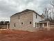 New construction home with brick and siding, showcasing the rear elevation on a cloudy day at 6945 Melody Ridge Rd, Buford, GA 30518