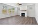 Bright living room featuring a fireplace, hardwood floors, and large windows at 6945 Melody Ridge Rd, Buford, GA 30518