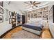 Well-lit bedroom with wood floors, a ceiling fan, custom shelving and a queen bed at 794 Ralph Mcgill Ne Blvd # 14, Atlanta, GA 30312