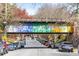 A colorful bridge over a road full of cars with mature trees lining the street at 794 Ralph Mcgill Ne Blvd # 14, Atlanta, GA 30312