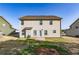 A home's back exterior featuring a yard and neutral siding at 2436 Planters Mill Way, Conyers, GA 30012