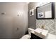 Chic powder room with gray walls, geometric tile accent, white vessel sink, and gold fixtures at 2436 Planters Mill Way, Conyers, GA 30012