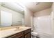 Bathroom with a single sink vanity and a shower-tub combo with white tiling at 2436 Planters Mill Way, Conyers, GA 30012