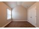 Carpeted bedroom with vaulted ceilings, a window, and a double door closet at 2436 Planters Mill Way, Conyers, GA 30012