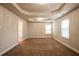 Spacious bedroom with tray ceiling, chandelier, carpet, and two windows with natural light at 2436 Planters Mill Way, Conyers, GA 30012