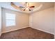 Bedroom with a tray ceiling, a ceiling fan, and a window with blinds at 2436 Planters Mill Way, Conyers, GA 30012