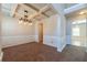 Elegant dining room with coffered ceilings, wainscoting, and stylish chandelier lighting at 2436 Planters Mill Way, Conyers, GA 30012