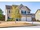 Attractive two-story home with brick and siding, two-car garage, and a lovely front yard at 2436 Planters Mill Way, Conyers, GA 30012