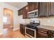 Close-up of kitchen with stainless steel oven/stove and dark cabinets at 2436 Planters Mill Way, Conyers, GA 30012