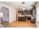 Open kitchen layout with stainless steel appliances, dark cabinets and bar seating at 2436 Planters Mill Way, Conyers, GA 30012