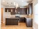 Modern kitchen features dark cabinets, stainless steel appliances, tile backsplash, and an island with pendant lighting at 2436 Planters Mill Way, Conyers, GA 30012