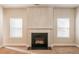 Cozy living room featuring fireplace and neutral paint, flanked by windows at 2436 Planters Mill Way, Conyers, GA 30012