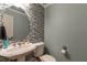 Stylish powder room featuring a modern vanity, sleek fixtures, and decorative tiled accent wall at 2585 Braselton Hwy, Buford, GA 30519