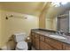 Bathroom featuring a granite countertop, wooden cabinets, toilet, and shower with glass door at 2585 Braselton Hwy, Buford, GA 30519