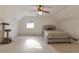 Neutral bedroom with light carpet, ceiling fan, a window, and a bed with patterned bedding at 2585 Braselton Hwy, Buford, GA 30519