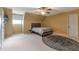 Bedroom with ceiling fan, a bed, a small window and carpeted floor at 2585 Braselton Hwy, Buford, GA 30519