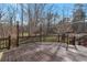 Large wooden deck surrounded by trees, providing a private outdoor space for relaxing and entertaining at 2585 Braselton Hwy, Buford, GA 30519