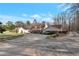 Charming home with covered parking and large circular driveway set among blooming shrubs at 2585 Braselton Hwy, Buford, GA 30519