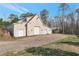 Detached garage with multiple bays and a carport, offering ample parking and storage space on a large lot at 2585 Braselton Hwy, Buford, GA 30519