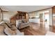 Open-concept living room flowing into the kitchen featuring hardwood floors, built-in shelving and plenty of space at 2585 Braselton Hwy, Buford, GA 30519