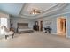 Serene primary bedroom featuring a tray ceiling, neutral tones, and ample space for relaxation at 2585 Braselton Hwy, Buford, GA 30519