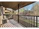 Inviting balcony with a chair and wrought-iron railing, perfect for relaxing with a view of mature trees at 104 River Run Dr, Atlanta, GA 30350