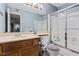 Cozy bathroom featuring a vanity with wooden cabinet and a shower with glass doors at 104 River Run Dr, Atlanta, GA 30350