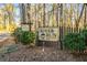 Welcoming sign for 'River Run Private Residences' amidst trees, plants and landscaping at 104 River Run Dr, Atlanta, GA 30350