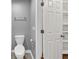 Bathroom featuring a toilet, door to built-in storage, and towel rack at 117 Lablanc Nw Way, Atlanta, GA 30327