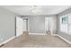 Spacious bedroom featuring neutral carpet, ceiling fan, and two windows with shuttered blinds at 117 Lablanc Nw Way, Atlanta, GA 30327