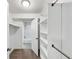 Spacious walk-in closet with built-in shelving and easy access to an updated bathroom featuring modern tile and fixtures at 117 Lablanc Nw Way, Atlanta, GA 30327