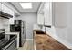 Cozy kitchen featuring white subway tile, stainless steel appliances and light wood floor at 117 Lablanc Nw Way, Atlanta, GA 30327