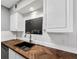 Kitchen sink with herringbone countertop and white cabinetry at 117 Lablanc Nw Way, Atlanta, GA 30327
