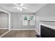Cozy living room with fireplace, wood floors, windows with shuttered blinds, and ceiling fan at 117 Lablanc Nw Way, Atlanta, GA 30327
