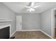 Well-lit living room featuring hardwood floors, fireplace, ceiling fan, and access to other rooms at 117 Lablanc Nw Way, Atlanta, GA 30327