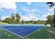 Well-maintained tennis court featuring updated lighting, a pristine surface, and a beautiful wooded backdrop at 117 Lablanc Nw Way, Atlanta, GA 30327