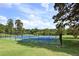 Scenic tennis courts with updated surfaces surrounded by lush greenery and framed by a clear, blue sky at 117 Lablanc Nw Way, Atlanta, GA 30327
