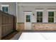 View of the home's backyard with a concrete patio and the exterior wall at 1604 Ruskin Way, Marietta, GA 30062