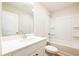 Bright bathroom features a white vanity and a shower-tub combo with white tile surround at 1604 Ruskin Way, Marietta, GA 30062