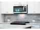 Modern microwave and backsplash with stainless steel appliances and tile backsplash at 1604 Ruskin Way, Marietta, GA 30062