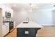 Modern kitchen features a quartz countertop island and stainless steel oven and microwave at 1604 Ruskin Way, Marietta, GA 30062