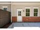 Backyard featuring a brick foundation, a door and windows with white trim at 1612 Ruskin Way, Marietta, GA 30062