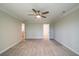 Carpeted bedroom with neutral paint, ceiling fan and view to another room at 1612 Ruskin Way, Marietta, GA 30062