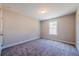 Cozy bedroom with neutral paint, plush carpet, and natural light from a window at 1612 Ruskin Way, Marietta, GA 30062