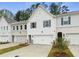 View of newly built townhomes with white siding, gray shutters, and attached garages at 1612 Ruskin Way, Marietta, GA 30062